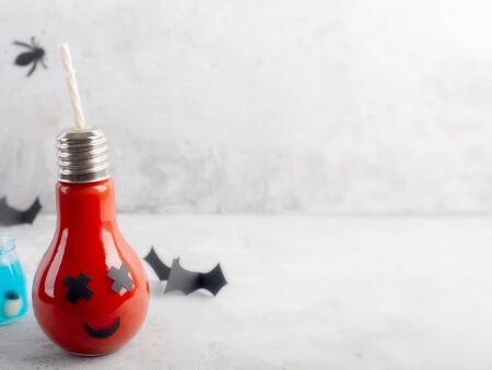 Halloween healthy tomato juice in the glass jar on a gray background with copy spaceの写真素材