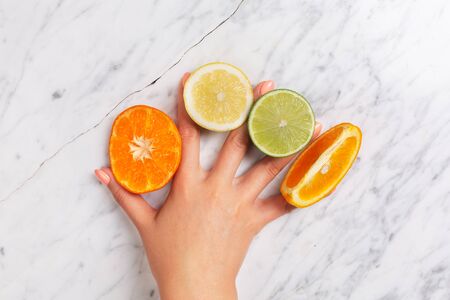 Woman's hand  holding citrus fruitの写真素材