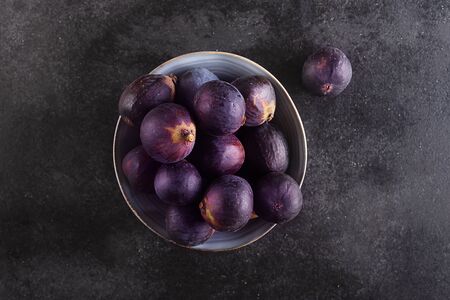 Fresh figs on a dark wood background , top view. Subtropical deciduous plant of the genus Ficus of the Mulberry family, top viewの写真素材