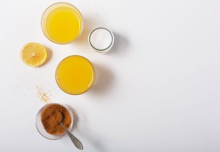 Homemade Isotonic Energy Drink and Ingredients. Glass With Yellow Liquid, Natural Sport Beverage on...