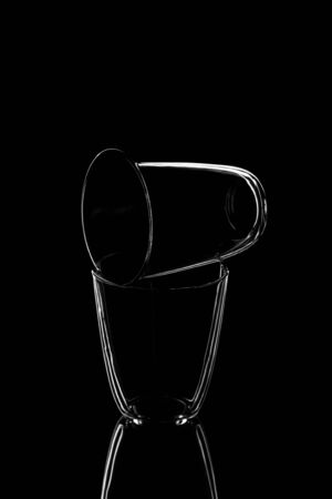 Empty water glasses isolated on a dark background, vertical orientationの写真素材