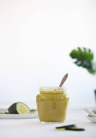 A delicious healthy breakfast with homemade cucumber jam and its ingredients on the tableの写真素材