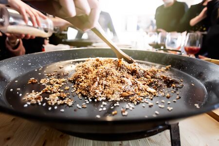 Pan with traditional Spanish paella. This dish usually prepared with rice, meat, seafood mussels, king prawns, langoustine and squids. This is typical cuisine of Valencia regionの写真素材