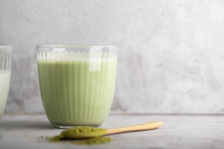 Hot green matcha chai latte with almond milk, organic modern drink with copy spaceの写真素材