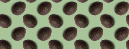 Seamless pattern of avocado on green background. Minimal isometric food texture