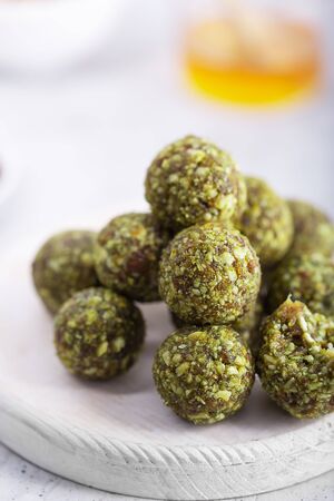 Modern no bake green chai matcha energy bites prepared with nuts, cocoa, chocolate, oats.の写真素材