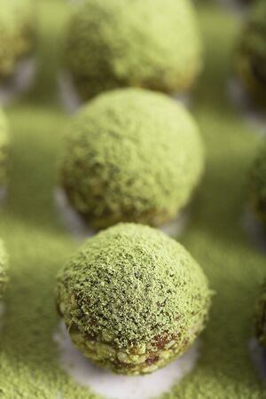 Modern no bake green chai matcha energy bites prepared with nuts, cocoa, chocolate, oats.の写真素材