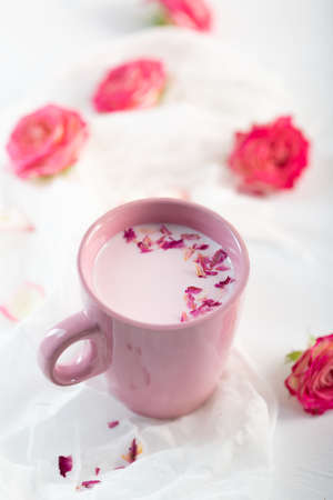 Rose moon milk in a cup for a better sleep. Ayurveda warm drink consumed before bed. Nice in case of sleeplessness, anxiety and insomniaの写真素材