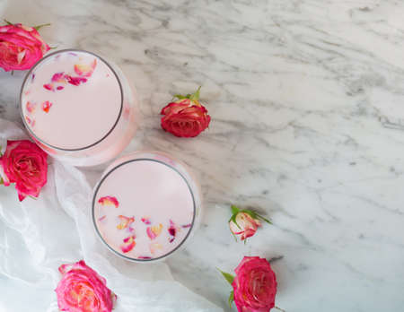 Rose moon milk for a better sleep. Ayurveda warm drink consumed before bed. Nice in case of sleeplessness, anxiety and insomnia. Top view, copy spaceの写真素材