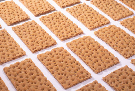 Crispbread on a white table, modern isometric creative minimalism concept, horizontal