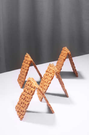 Crispbread on a white table, modern isometric creative minimalism concept