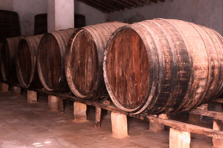 Red wine barrels stacked in the old cellar of the vinery in Spain, Alicanteの写真素材