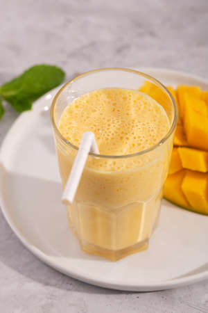 Lassi is a popular traditional cold drink with mango in India. Lassi consists of yogurt, water, spices and sometimes fruit and iceの写真素材