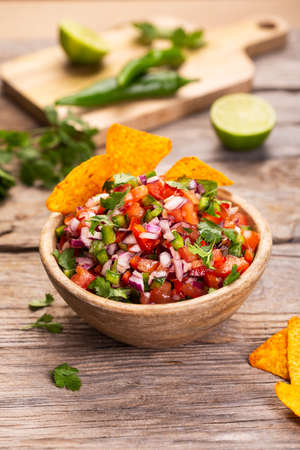 Fresh bowl of salsa pico de gallo, mexican cuisine, vertical imageの写真素材