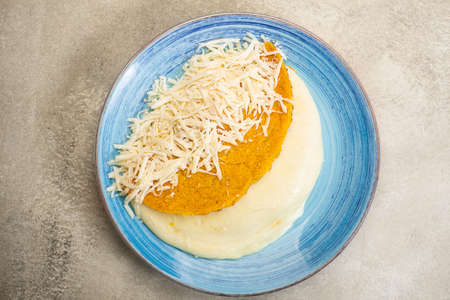 Arepa stuffed with cheese on a plate prepared from cornmeal, traditional cuisine of Colombia and Venezuelaの写真素材
