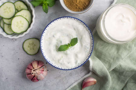 Traditional Indian Raita with cucumber, greek yoghurt and coriander, top view, concrete backgroundの写真素材