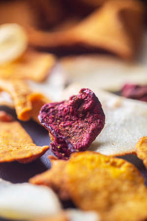 Dried chips from organic vegetables: potatoes, carrots and beets close-up. Selective focusの写真素材