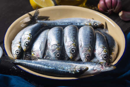 Sardines or European pilchard in a bowl. Fish is widely used in the cuisines of Greece, Spain and...
