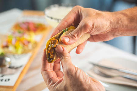Tacos is a traditional Mexican dish consisting of a small corn or wheat flapjack tortilla topped...