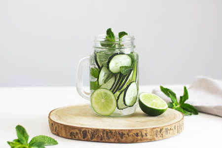 Infused water with cucumber, lime and mint in a glass jarの写真素材