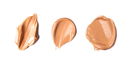 Three tone cream smear swatches isolated on white background. Beige color cosmetic product samples