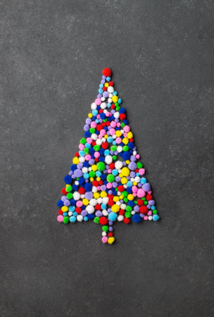 Creative Christmas tree made from colorful fluffy balls on black backgroundの写真素材