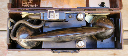 An old phone on wooden backgroundの写真素材