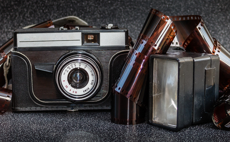 An old camera, flash and film tapeの写真素材