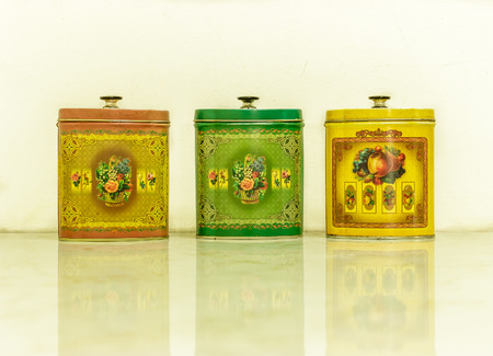 Three oval vintage colorful tin storage with cover on white backgroundの写真素材