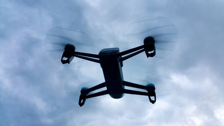 shadow drone flying in the cloudy skyの写真素材