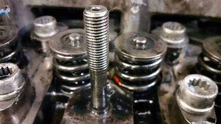 A bolt and springs on the disassembled engine. Close-upの写真素材