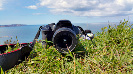 camera is lying on the green grass, close upの写真素材