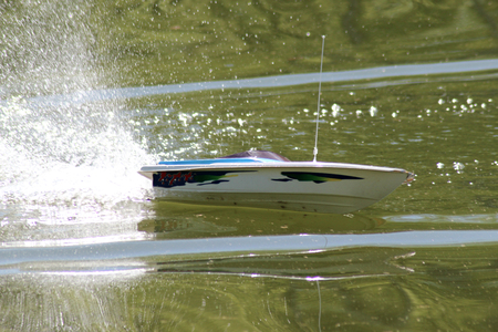Boat model in motion on the water. Outdoor in sunny day.の写真素材