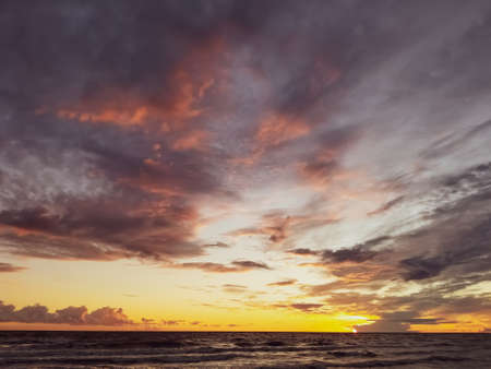 stormy sea against the background of a color sunset. Dramatic sky over storm sea. Baltic seaの写真素材