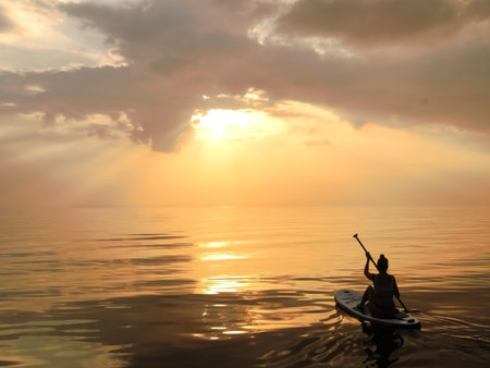 Experience the serene beauty of a tranquil sunset over calm waters, as the sun casts a warm golden...