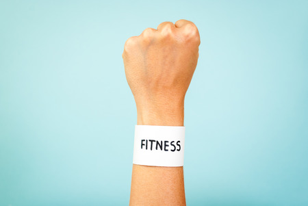 Fitness woman hand concept on blue background