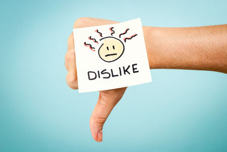 Dislike concept with hand on blue backgroundの写真素材