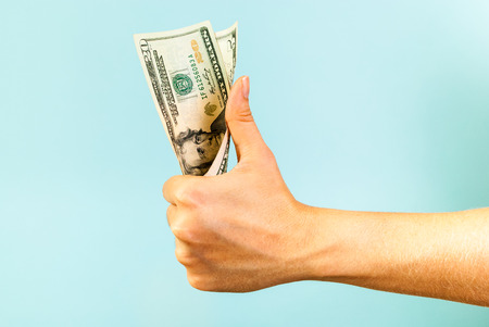 Money like hand on blue backgroundの写真素材