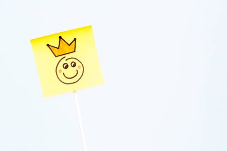 Illustration of a happy face of king smiling with a crowd on stick holder with blue background.の写真素材