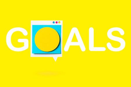 Isolated paper cutout of speech buggle with goals text. Goals banner on yellow background.の写真素材