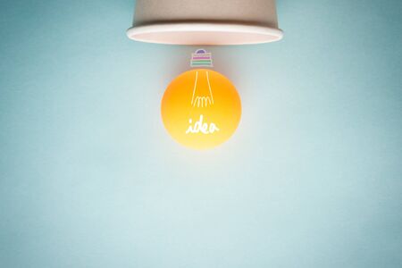 Concept of creative idea, inspiration, innovation and bulb light with ping pong ball and paper cup...
