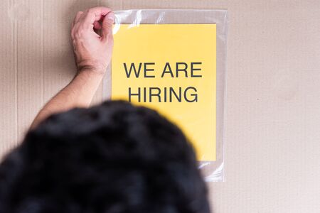 Man searching new job for change concept. We are hiring word on cardboard box background.の写真素材