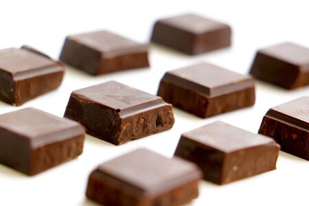 pattern rows of chocolate blocks laid out on white