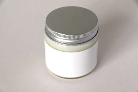 Isolated glass jar packaging with metal lid and white label