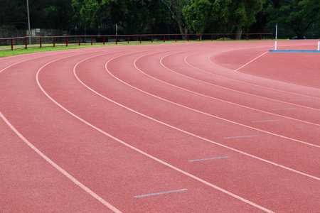 White lines forming lanes of an athletics track made of red rubberの写真素材