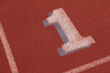 First lane on an athletics track showing a number oneの写真素材