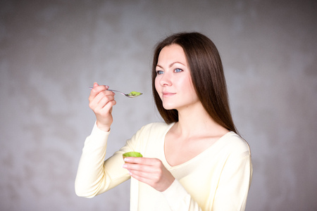 Beautiful young girl holding kiwi. Healthy food. vegetarianismの写真素材