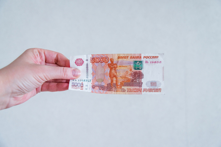 a womans hand holds a five thousandth note. Russian money. The concept of a bribe. selective focus....