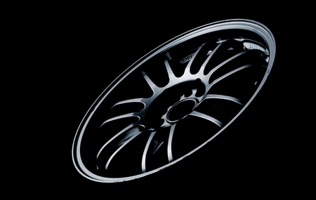 Racing wheel bronze color isolated with black background.の写真素材