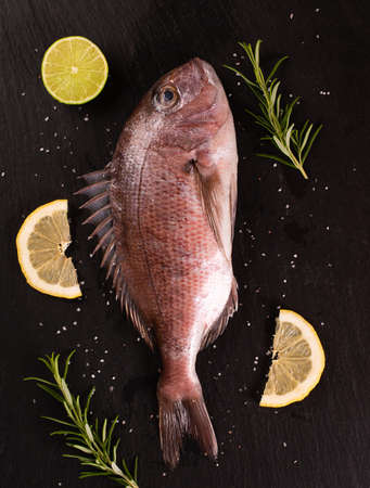 Old strainer full of ripe red cherries in the gardenの写真素材